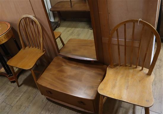 An Ercol elm cheval mirror and two Ercol comb back chairs